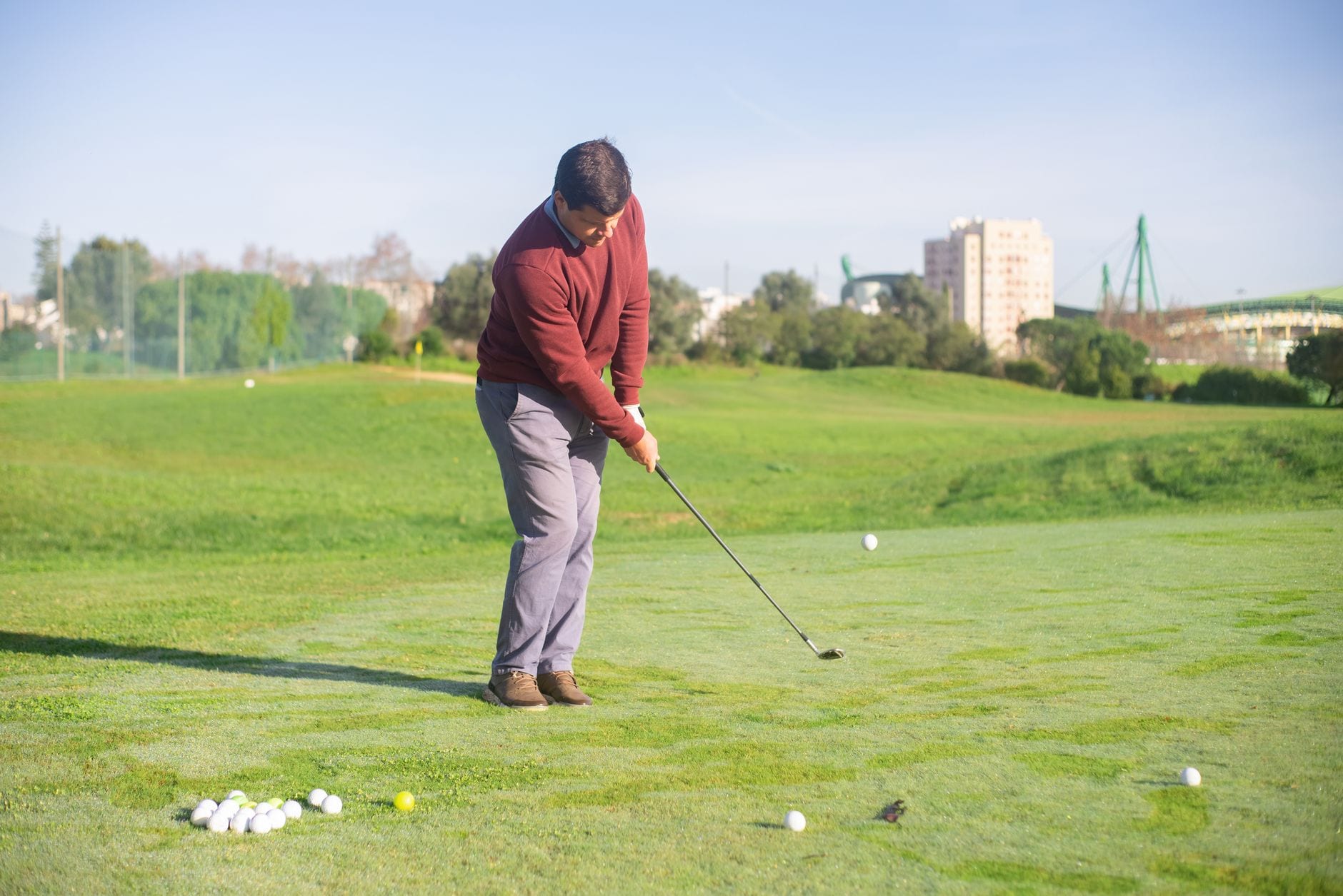 A golfer standing on the course on a sunny day