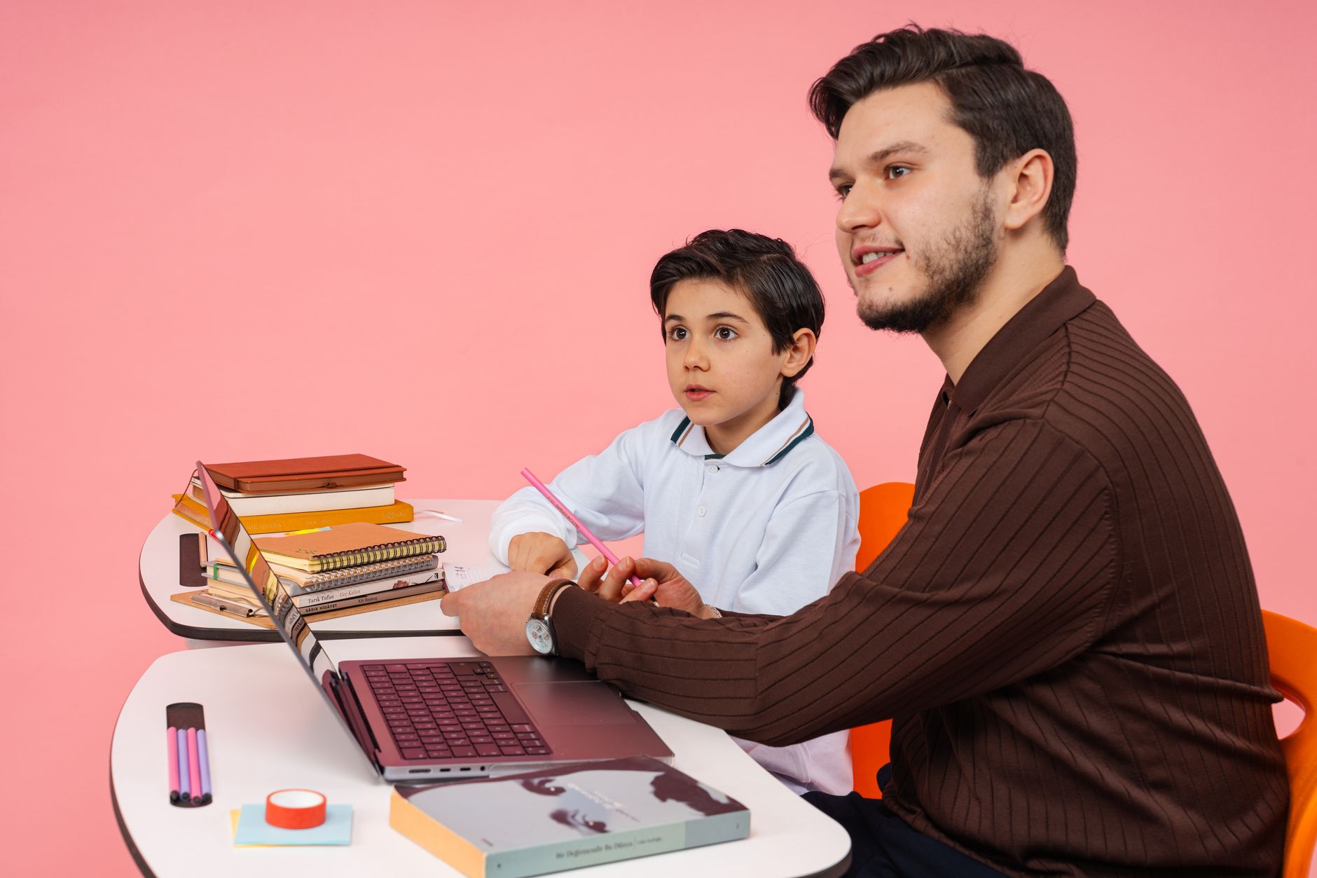 Student and mentor working through homework together at a desk